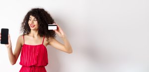 Online Shopping Concept Elegant Curlyhaired Woman Red Dress Showing Plastic Credit Card Empty 1 Scaled